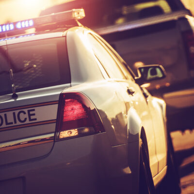 State Police Traffic Stop on a Highway. Police Cruiser with Flashing Lights.