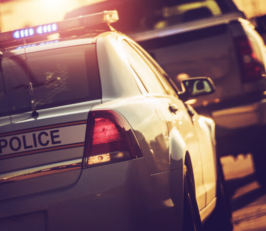 State Police Traffic Stop on a Highway. Police Cruiser with Flashing Lights.